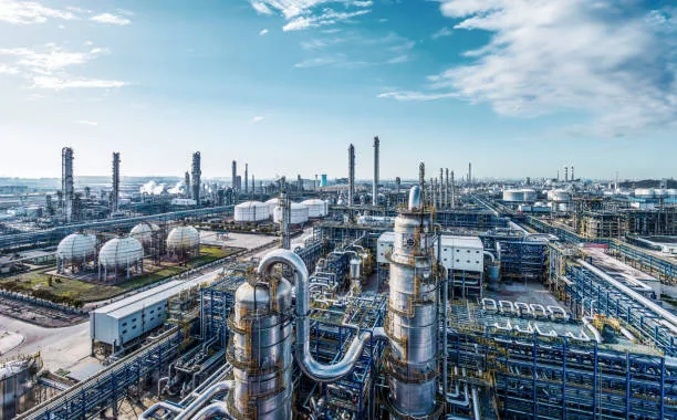Spherical storage vessels, blue pipework and processing columns across an industrial site